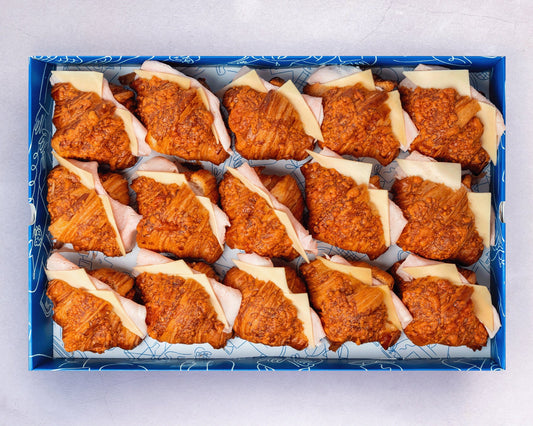 Bakehouse Occasions mini ham and cheese croissants in a catering box.