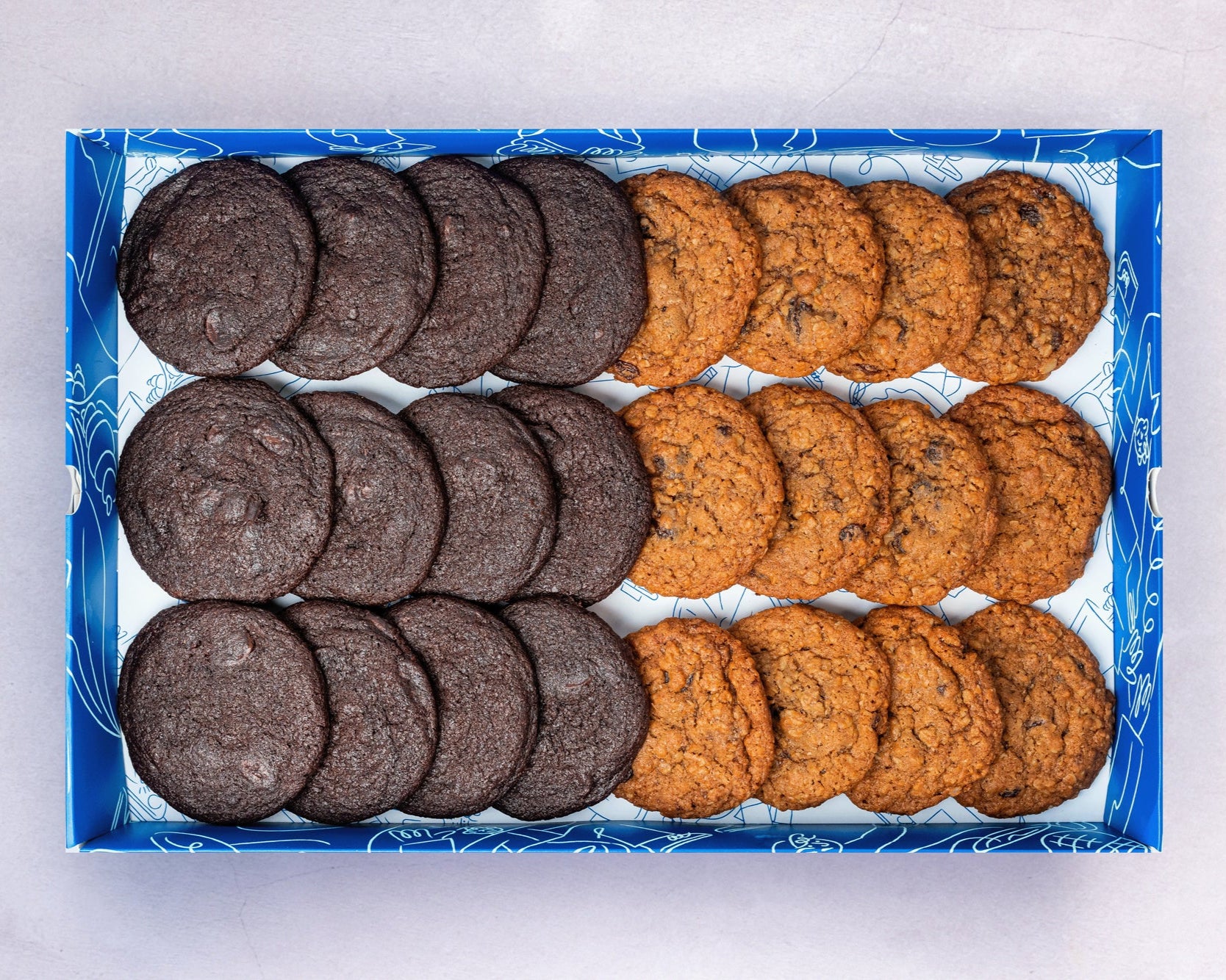 A Box of bakehouse occasions mini double chocolate and apple and raisin cookies.