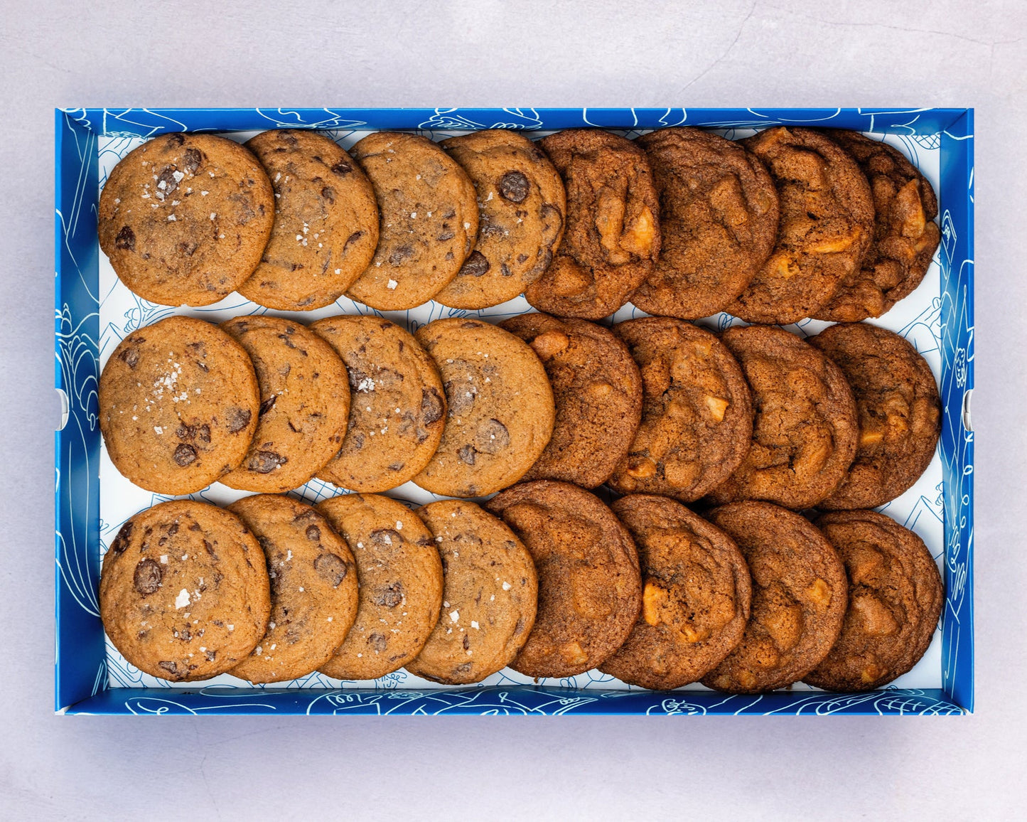 A Box of bakehouse occasions mini chocolate sea salt and apple pie cookies.