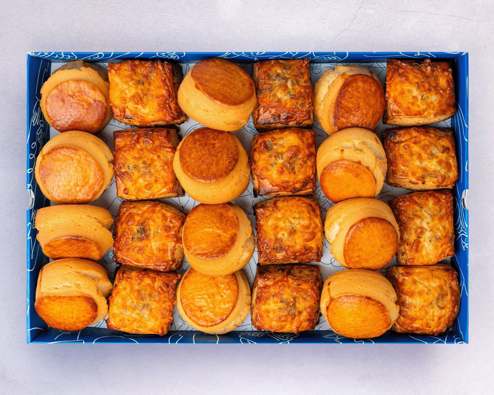 Bakehouse Occasions offers a catering scone box with selection of plain, apple raisin, and cheese & onion scones.