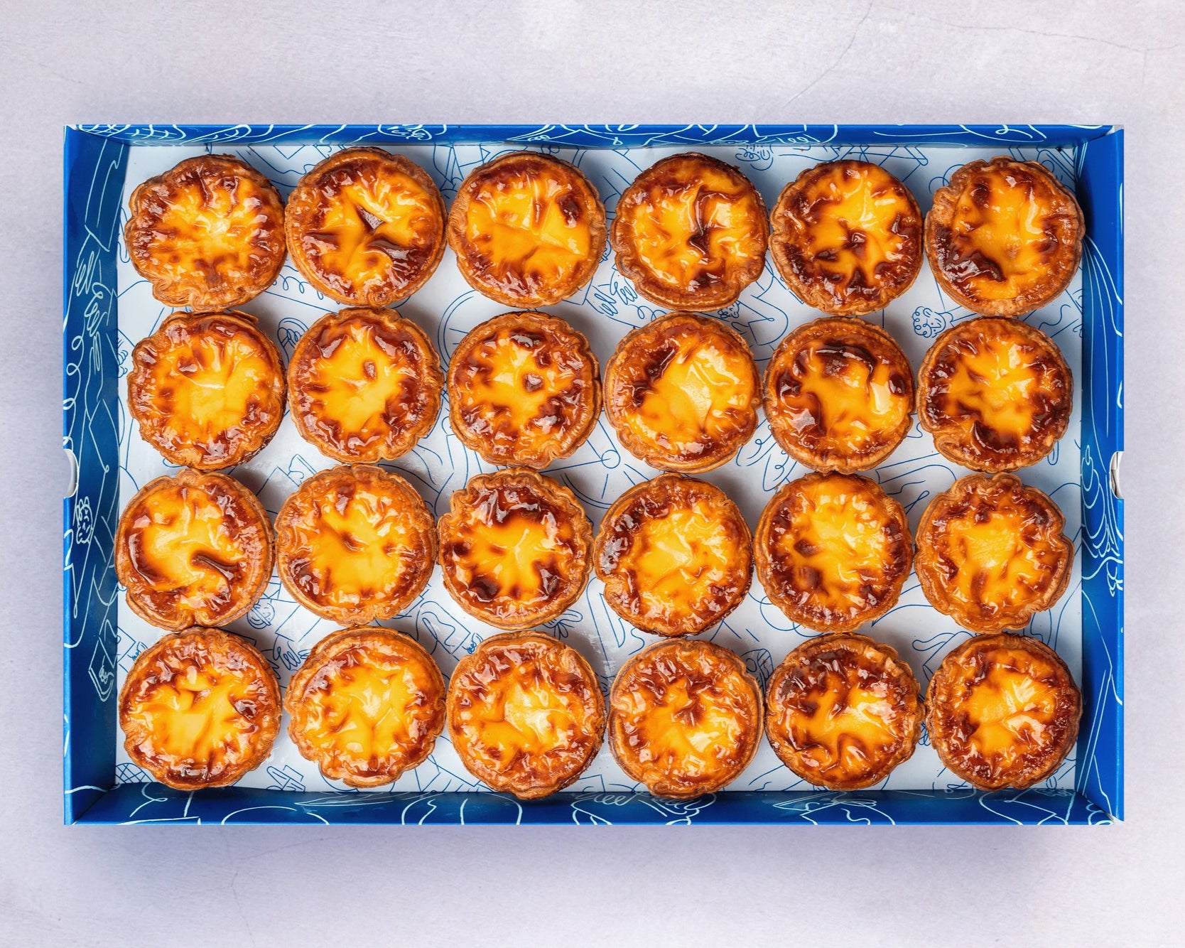 A box of Bakehouse signature sourdough egg tart, available for online order, catering, and party.