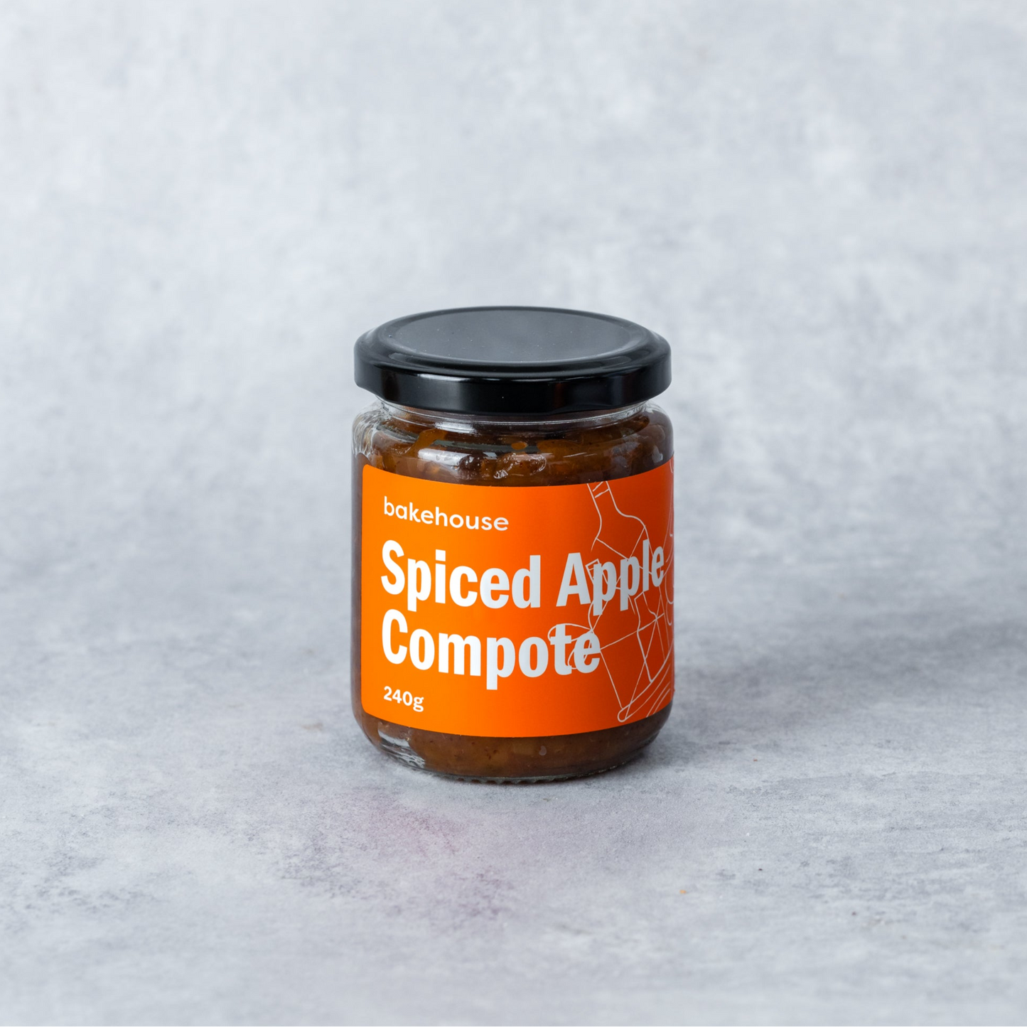 A jar of spiced apple compote with a Bakehouse orange label.