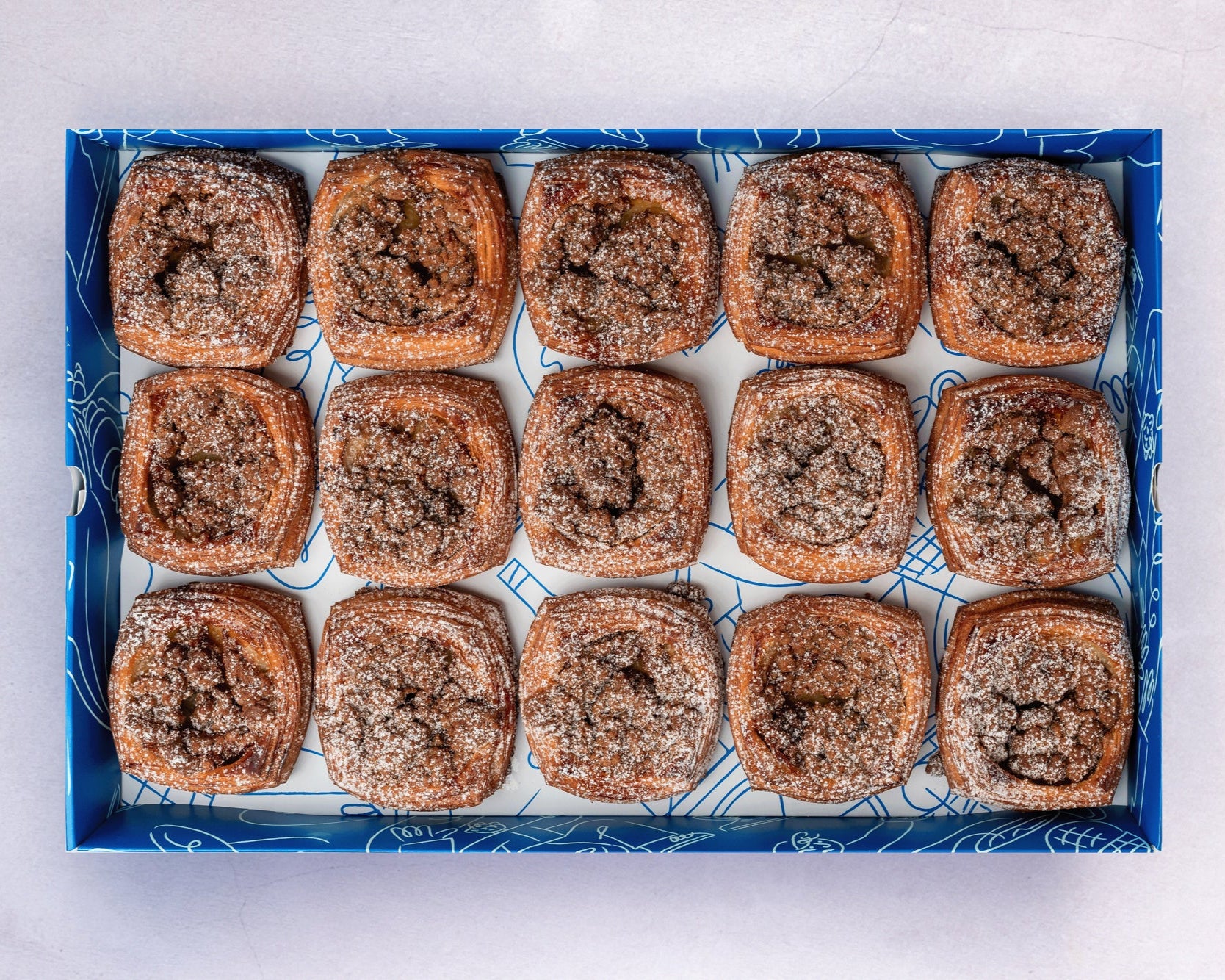 A box of Bakehouse Occasions mini banana caramel crumble danish with salted caramel drizzle.