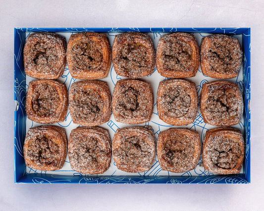A box of Bakehouse Occasions mini banana caramel crumble danish with salted caramel drizzle.